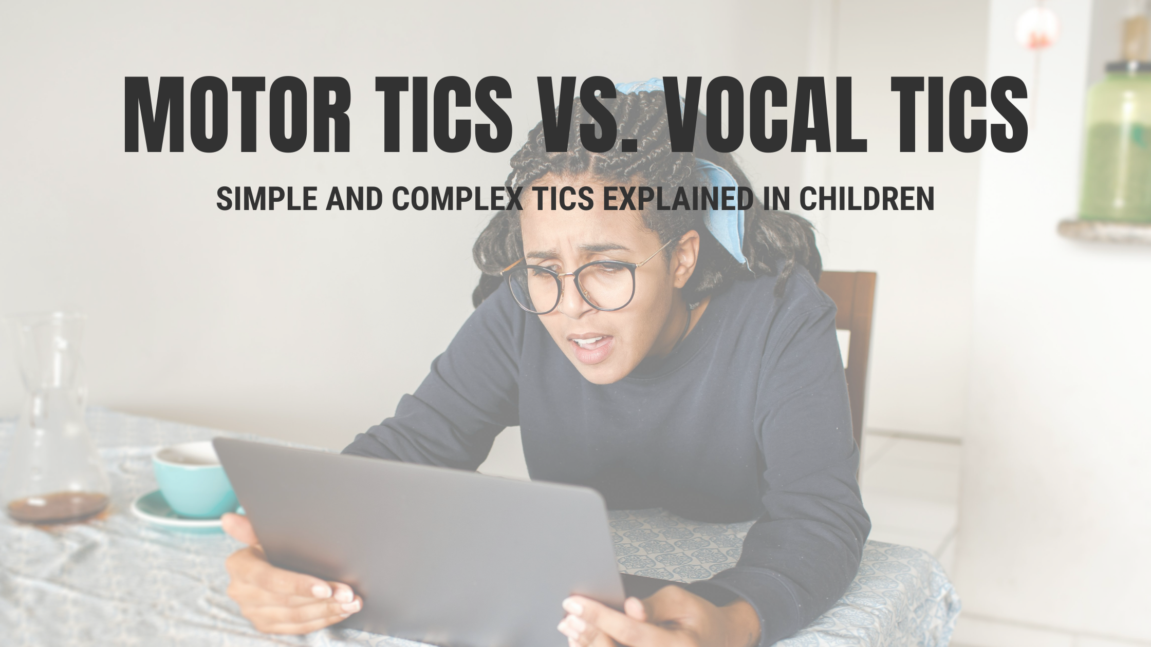 Parent looking concerned while reading about motor tics vs. vocal tics on a laptop at a kitchen table.